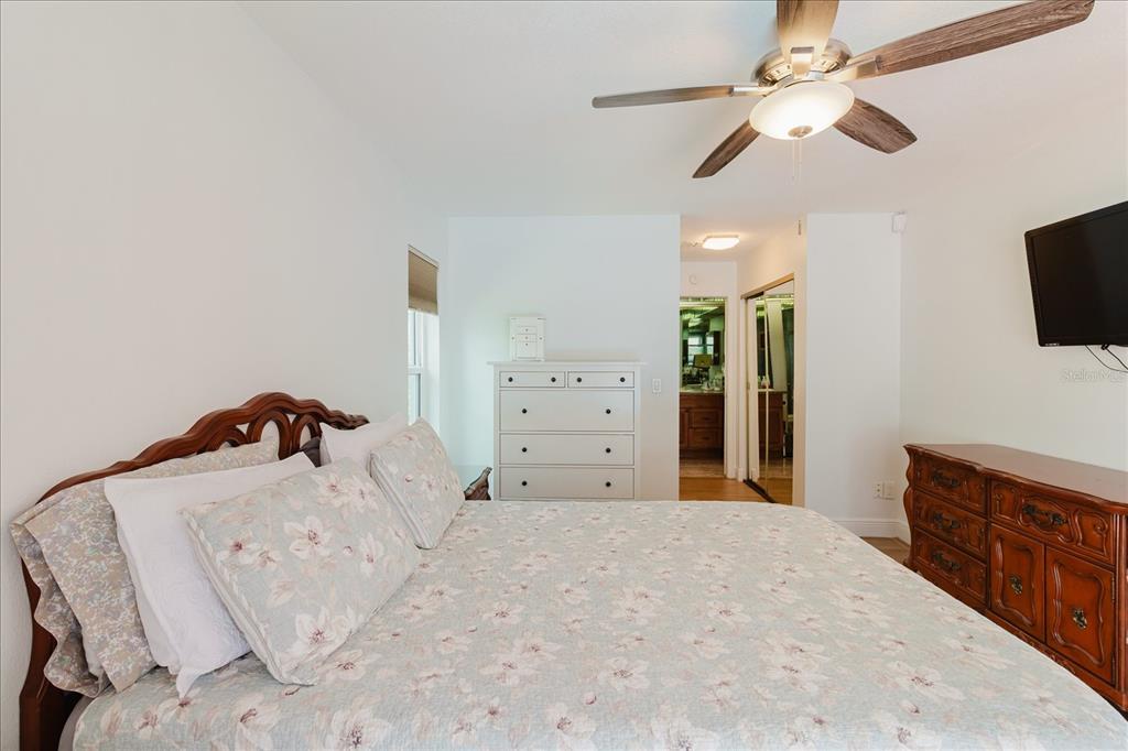 8112 Golden Bear Loop Port Richey, FL 34668 - Photo 42 of 88 a bedroom with a bed and a flat screen tv