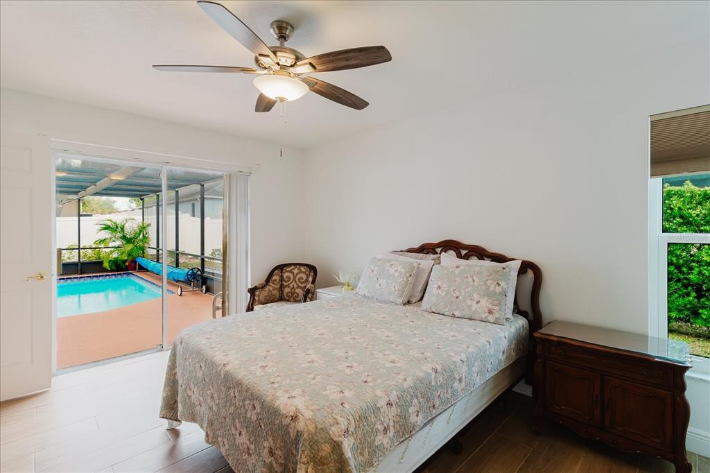 8112 Golden Bear Loop Port Richey, FL 34668 - Photo 43 of 88 a bedroom with a bed and a ceiling fan