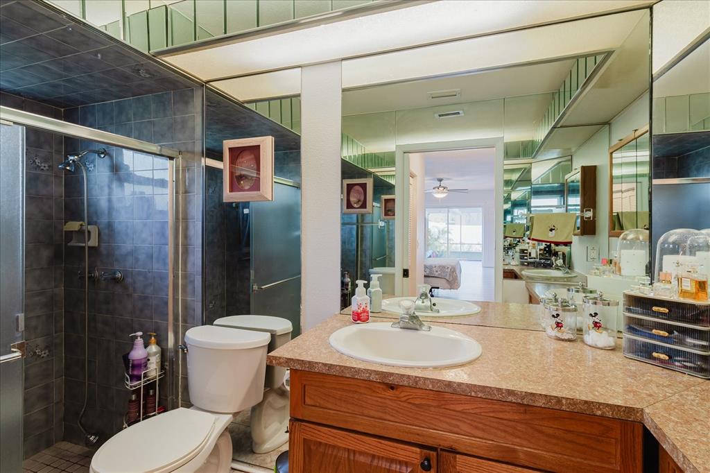 8112 Golden Bear Loop Port Richey, FL 34668 - Photo 46 of 88 a bathroom with a sink toilet vanity and shower