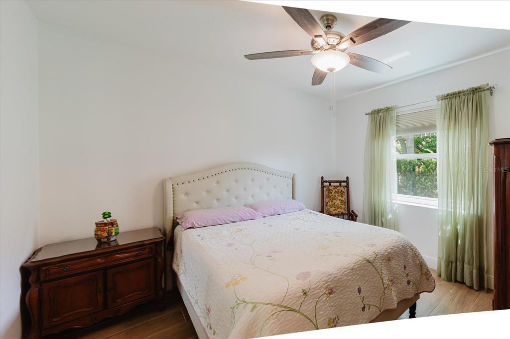 8112 Golden Bear Loop Port Richey, FL 34668 - Photo 47 of 88 a bedroom with a bed and a chandelier