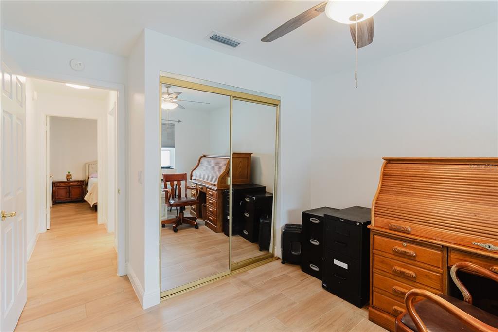 8112 Golden Bear Loop Port Richey, FL 34668 - Photo 53 of 88 a bedroom with a bed and a view of en suite bathroom