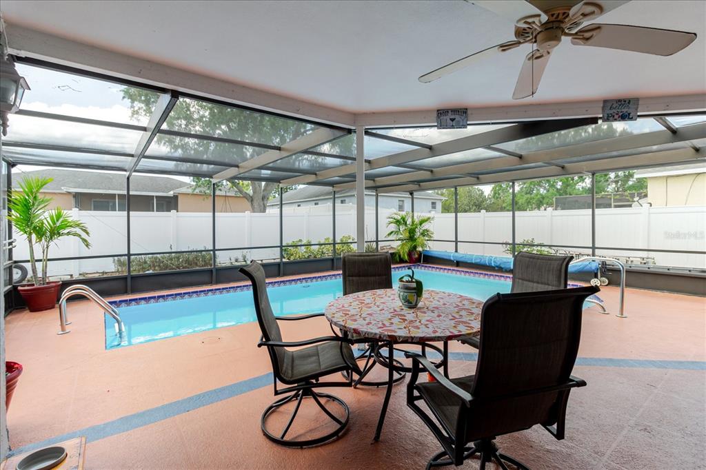 8112 Golden Bear Loop Port Richey, FL 34668 - Photo 57 of 88 a dining room with furniture and a floor to ceiling window