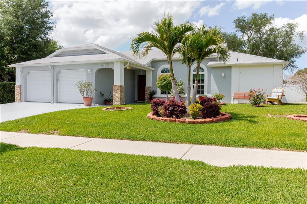 8112 Golden Bear Loop Port Richey, FL 34668 - Photo 6 of 88 a front view of a house with a garden and plants