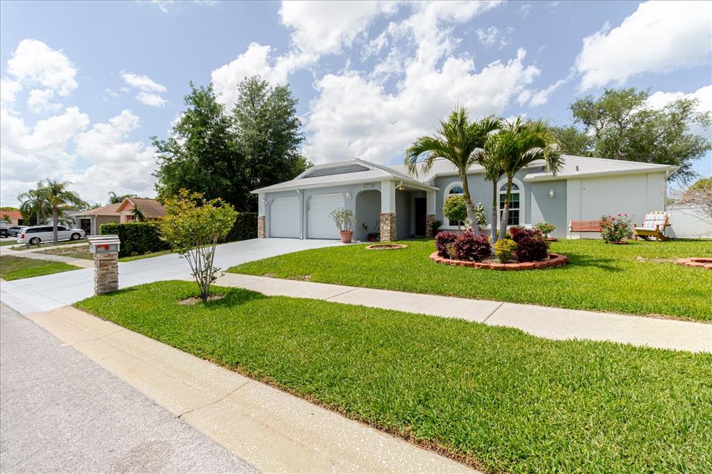 8112 Golden Bear Loop Port Richey, FL 34668 - Photo 7 of 88 a front view of house with yard and green space
