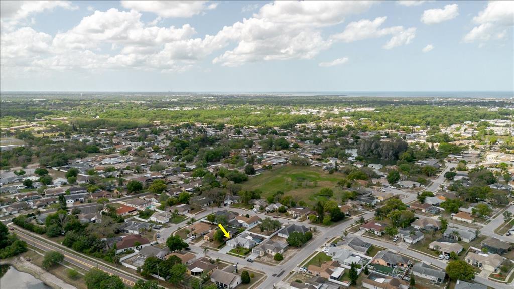 8112 Golden Bear Loop Port Richey, FL 34668 - Photo 72 of 88 an aerial view of residential houses with outdoor space and trees