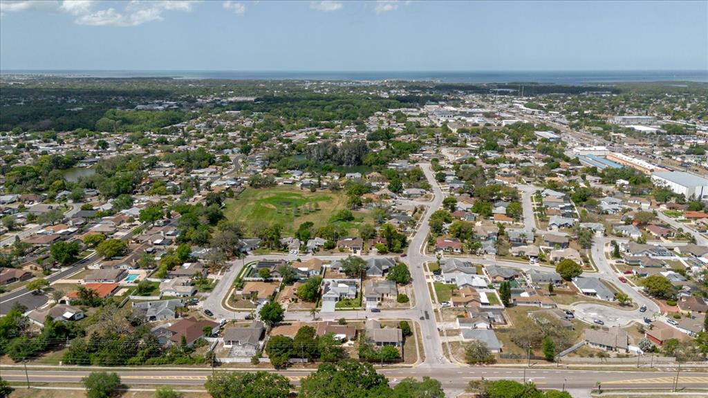8112 Golden Bear Loop Port Richey, FL 34668 - Photo 77 of 88 an aerial view of residential houses with outdoor space and trees
