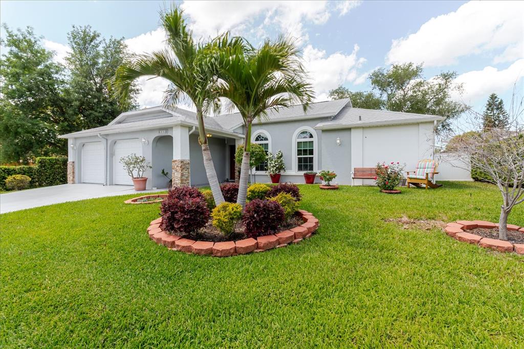 8112 Golden Bear Loop Port Richey, FL 34668 - Photo 8 of 88 a front view of a house with a yard and garage