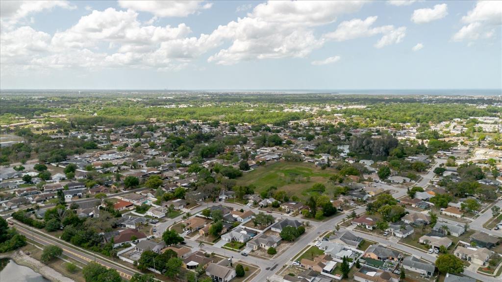 8112 Golden Bear Loop Port Richey, FL 34668 - Photo 85 of 88 an aerial view of residential houses with outdoor space and trees