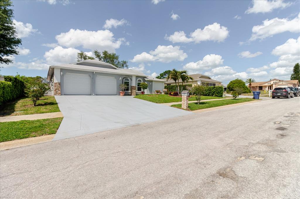 8112 Golden Bear Loop Port Richey, FL 34668 - Photo 10 of 88 front view of a house with a yard and a street