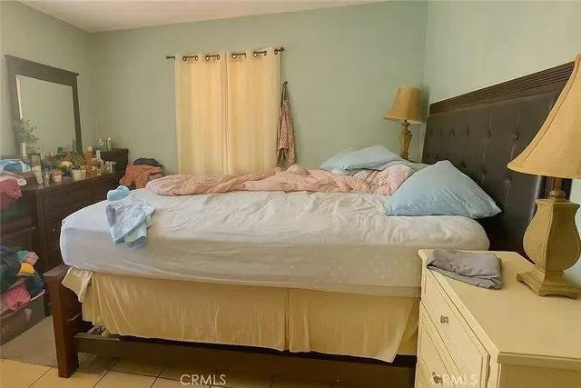 a bedroom with a bed and a dresser in it