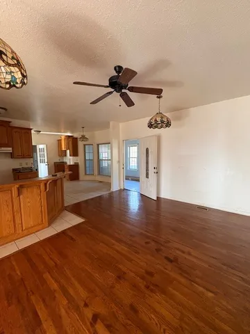a view of a room with wooden floor