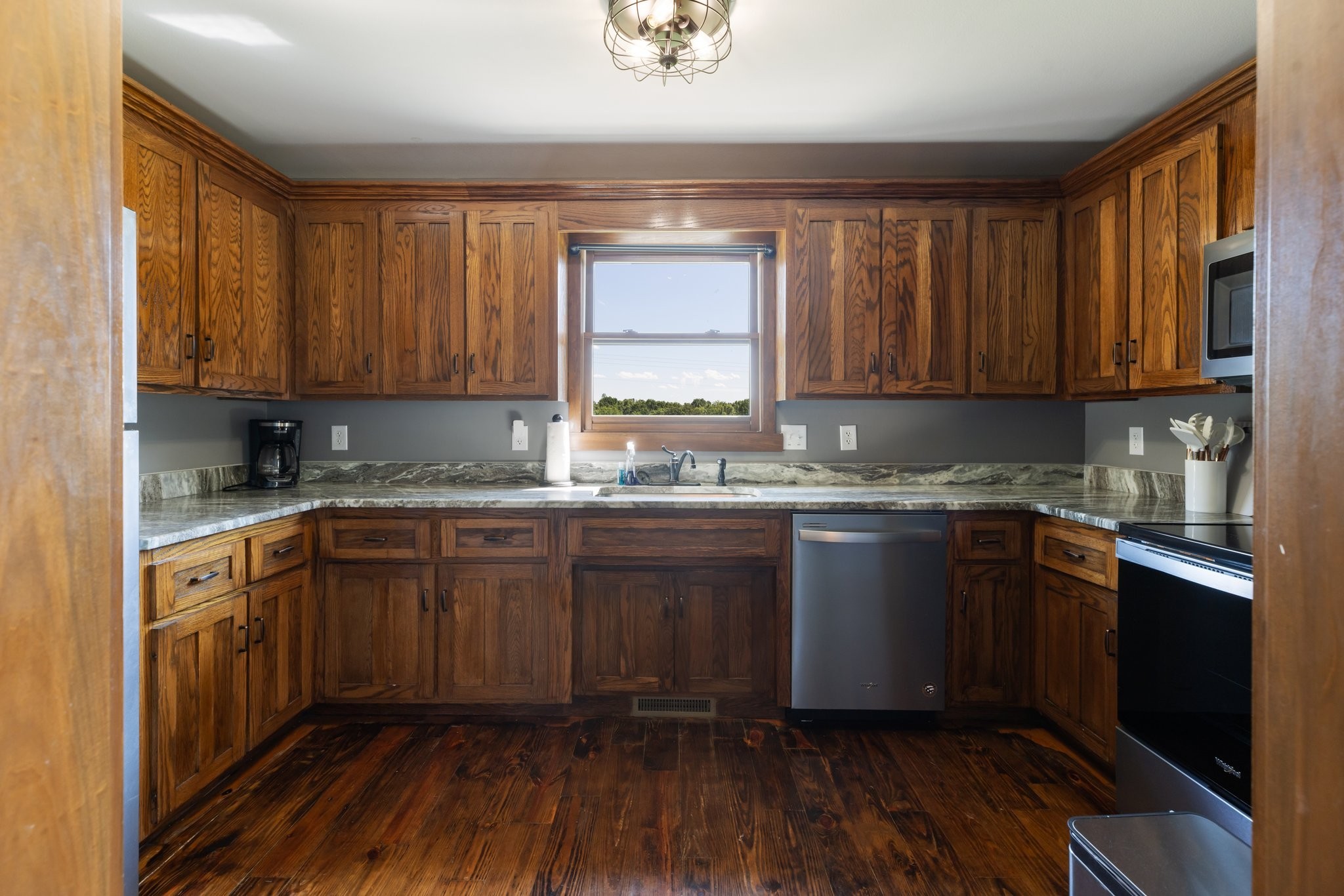 2890 Ellis Lane Palmyra, TN 37142 - Photo 11 of 19 a kitchen with granite countertop wooden floors a sink and cabinets