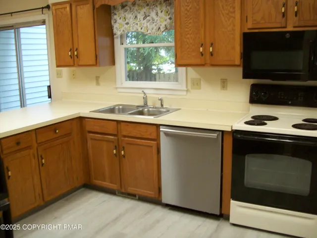 a kitchen with sink cabinets and window