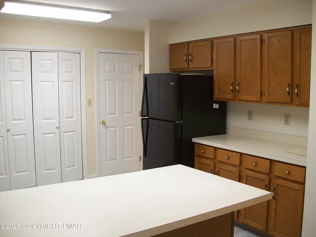 a kitchen with a refrigerator and cabinets