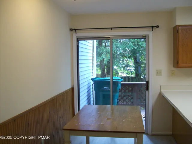 a view of a floor to ceiling window and an outdoor kitchen