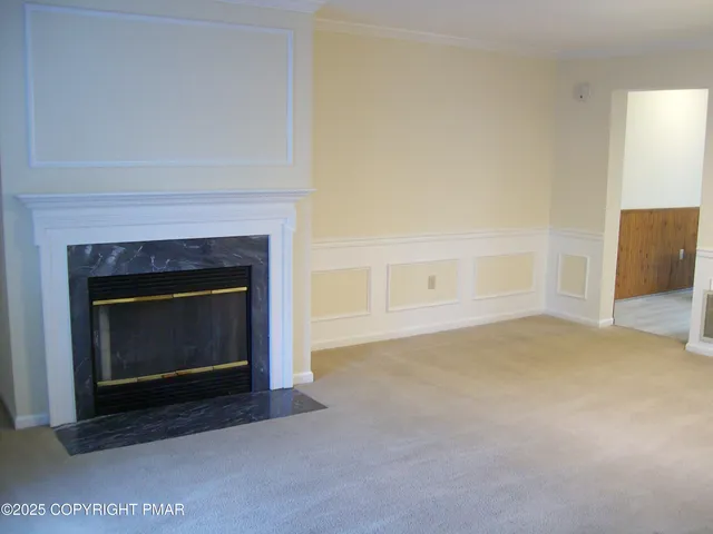 a view of empty room with a fireplace