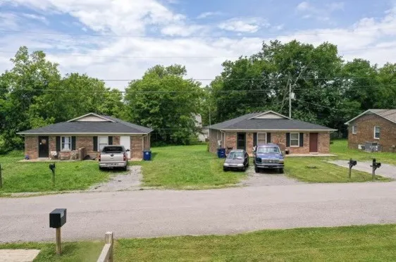 a view of a house with a garden and pathway