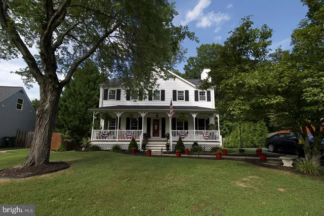 a front view of a house with a garden and swimming pool