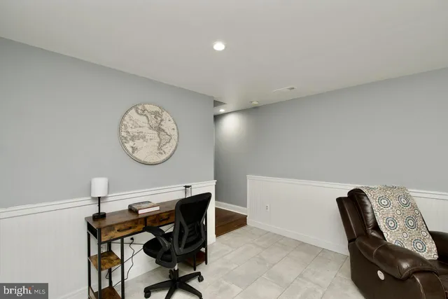 a view of a workspace with furniture and a chair