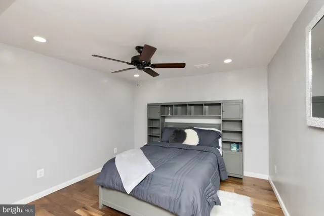 a bedroom with a bed and a ceiling fan
