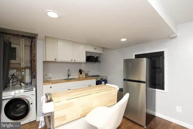 a kitchen with stainless steel appliances a refrigerator and a stove top oven