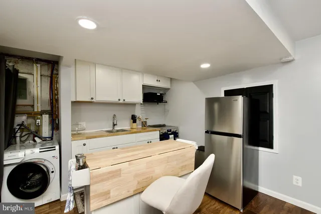 a kitchen with stainless steel appliances a refrigerator and a stove top oven