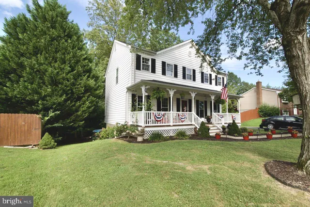 a living room with furniture kitchen view and a fireplace