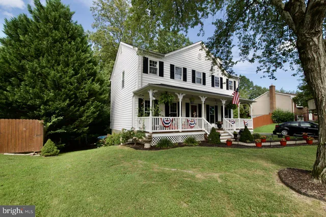 a front view of a house with a yard table and chairs