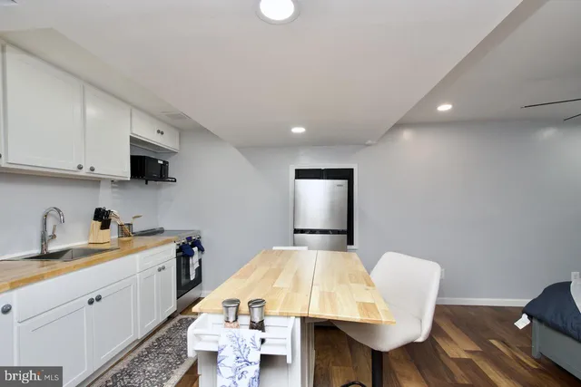 a kitchen with a sink and a refrigerator