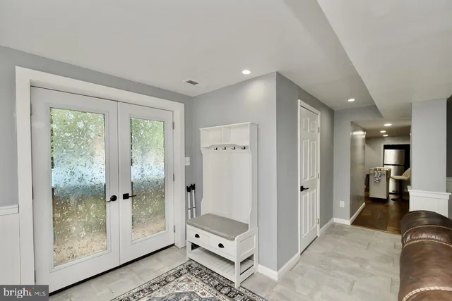a spacious bathroom with a glass shower door and a window