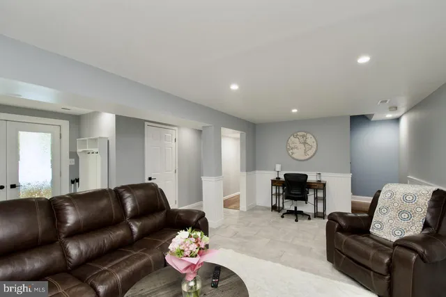 a living room with furniture kitchen view and a fireplace