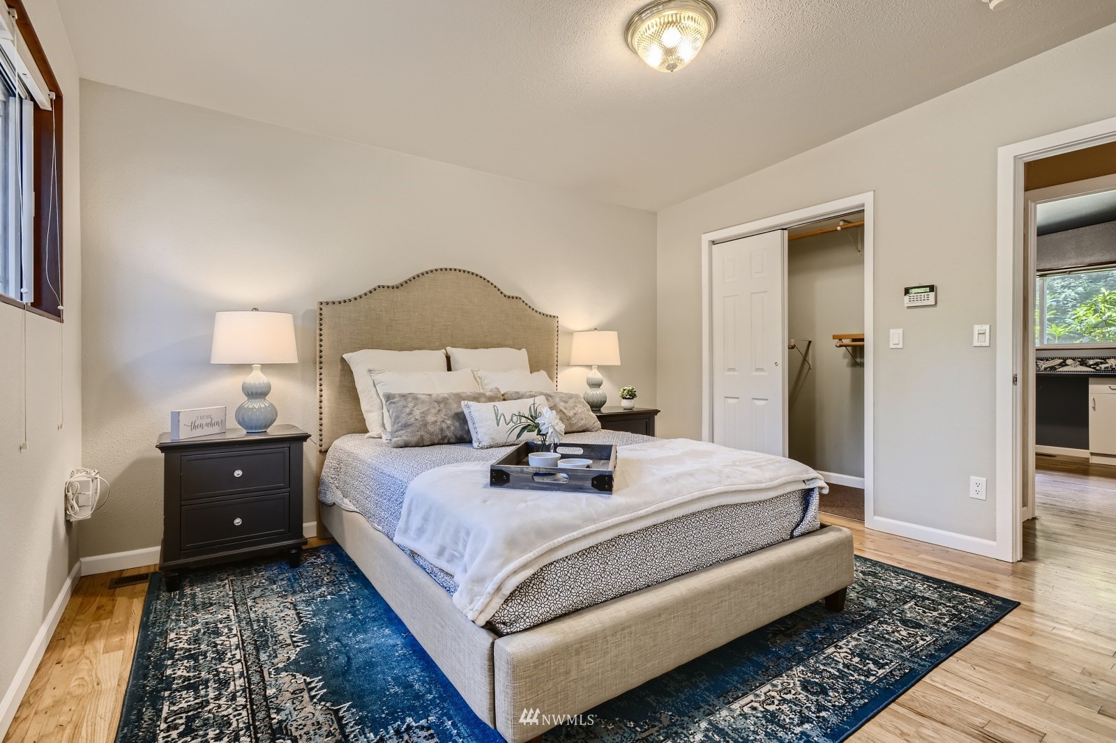 2207 242nd Street Southwest Bothell, WA 98021 - Photo 16 of 28 a bed room with a bed and a lamp