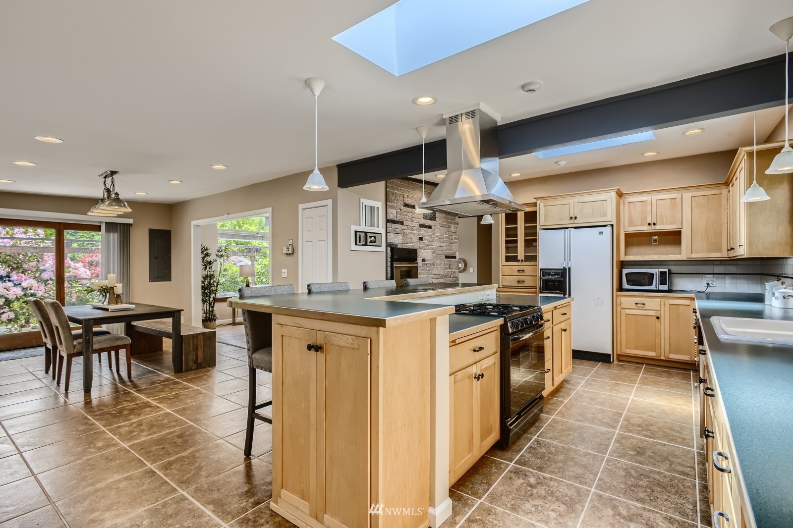 2207 242nd Street Southwest Bothell, WA 98021 - Photo 7 of 28 a kitchen with stainless steel appliances kitchen island granite countertop a sink and cabinets