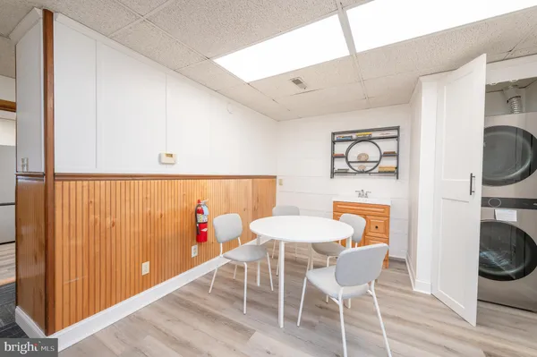 a view of a workspace with furniture and wooden floor