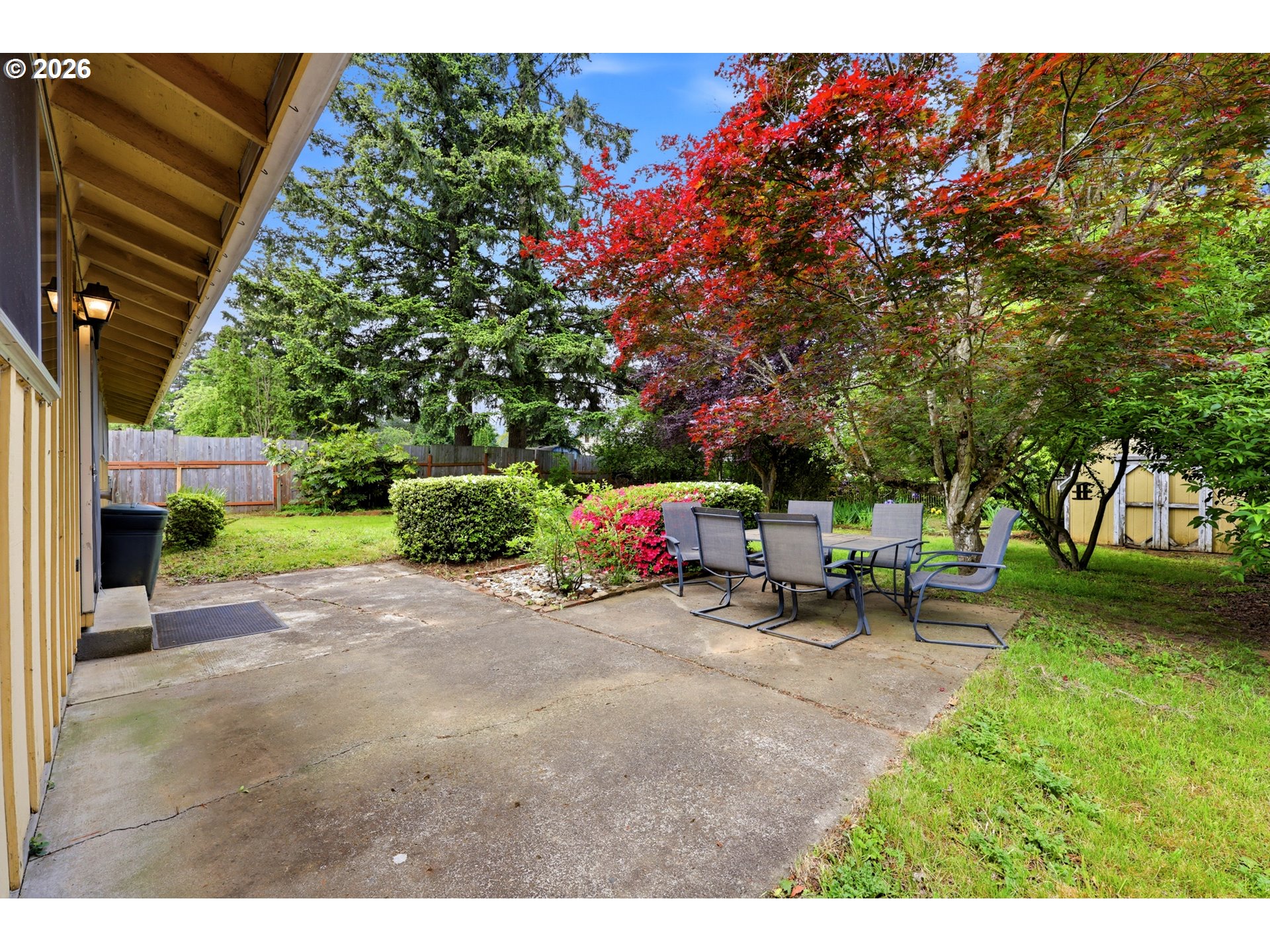 3003 Southeast 162nd Avenue Portland, OR 97236 - Photo 27 of 41 a backyard of a house with table and chairs