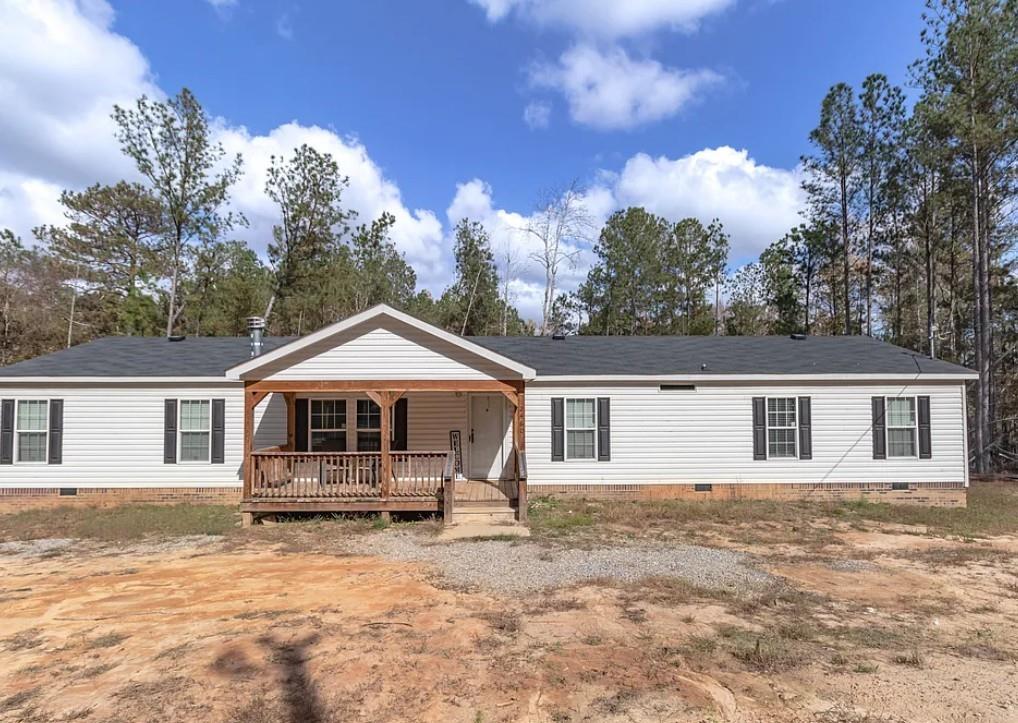 2460 Black Shoals Road Northeast Conyers, GA 30012 - Photo 1 of 1 a house with trees in the background