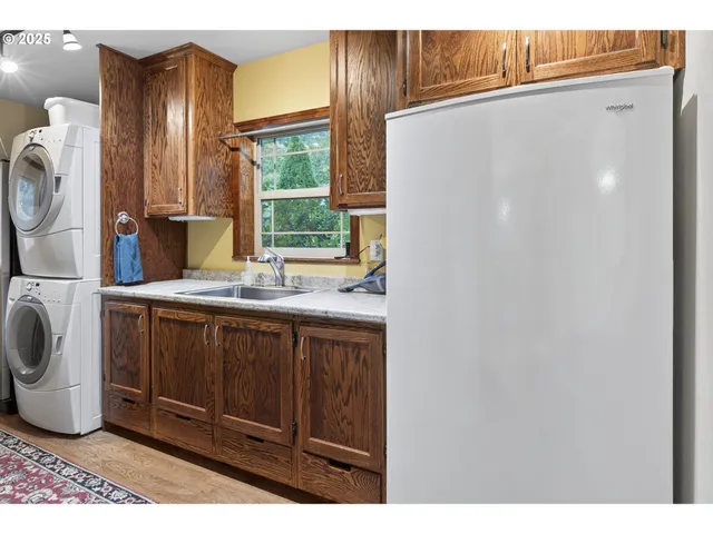 a kitchen with a refrigerator and a sink