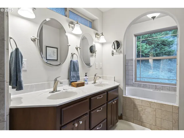 a bathroom with a double vanity sink and a mirror