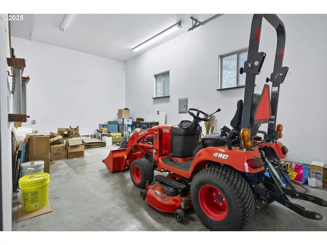 a view of a grassy field with trees in the background