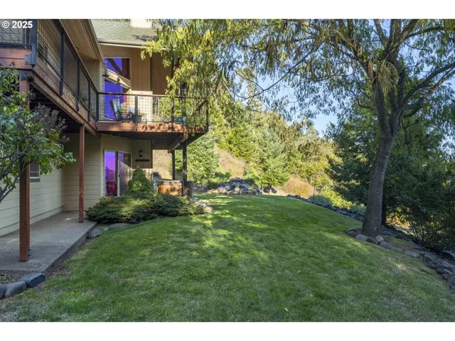 a front view of a house with a yard and trees