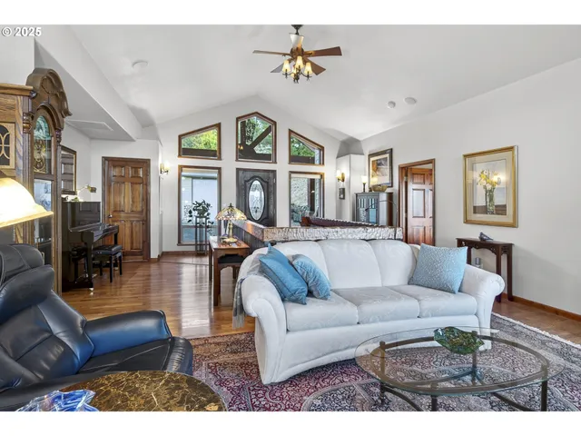 a living room with furniture a chandelier and a large window