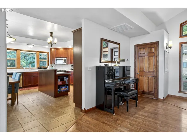 a kitchen with stainless steel appliances kitchen island granite countertop a refrigerator and a stove top oven