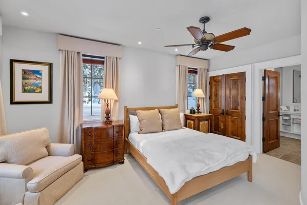 a bed room with a bed and a chandelier