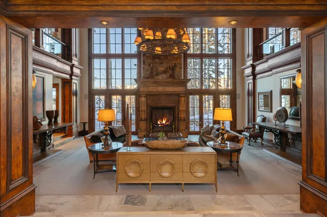 a living room with patio furniture and a fireplace