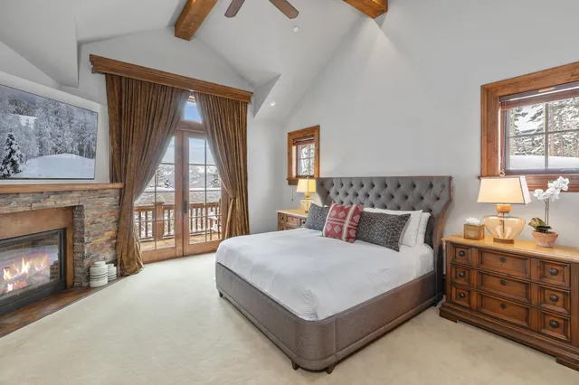 a bedroom with a bed and a fireplace