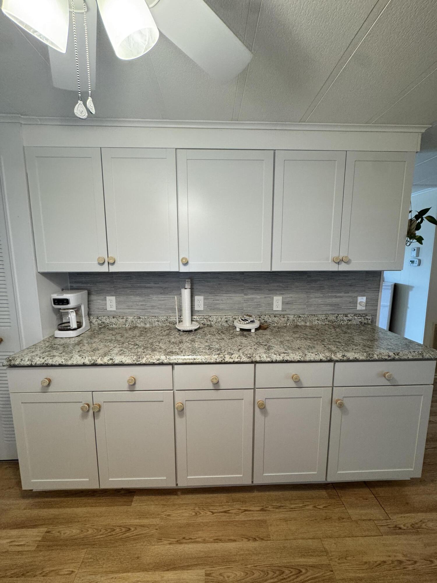 17 Verde Vista Fort Pierce, FL 34951 - Photo 11 of 35 a white kitchen with granite countertop cabinets and sink