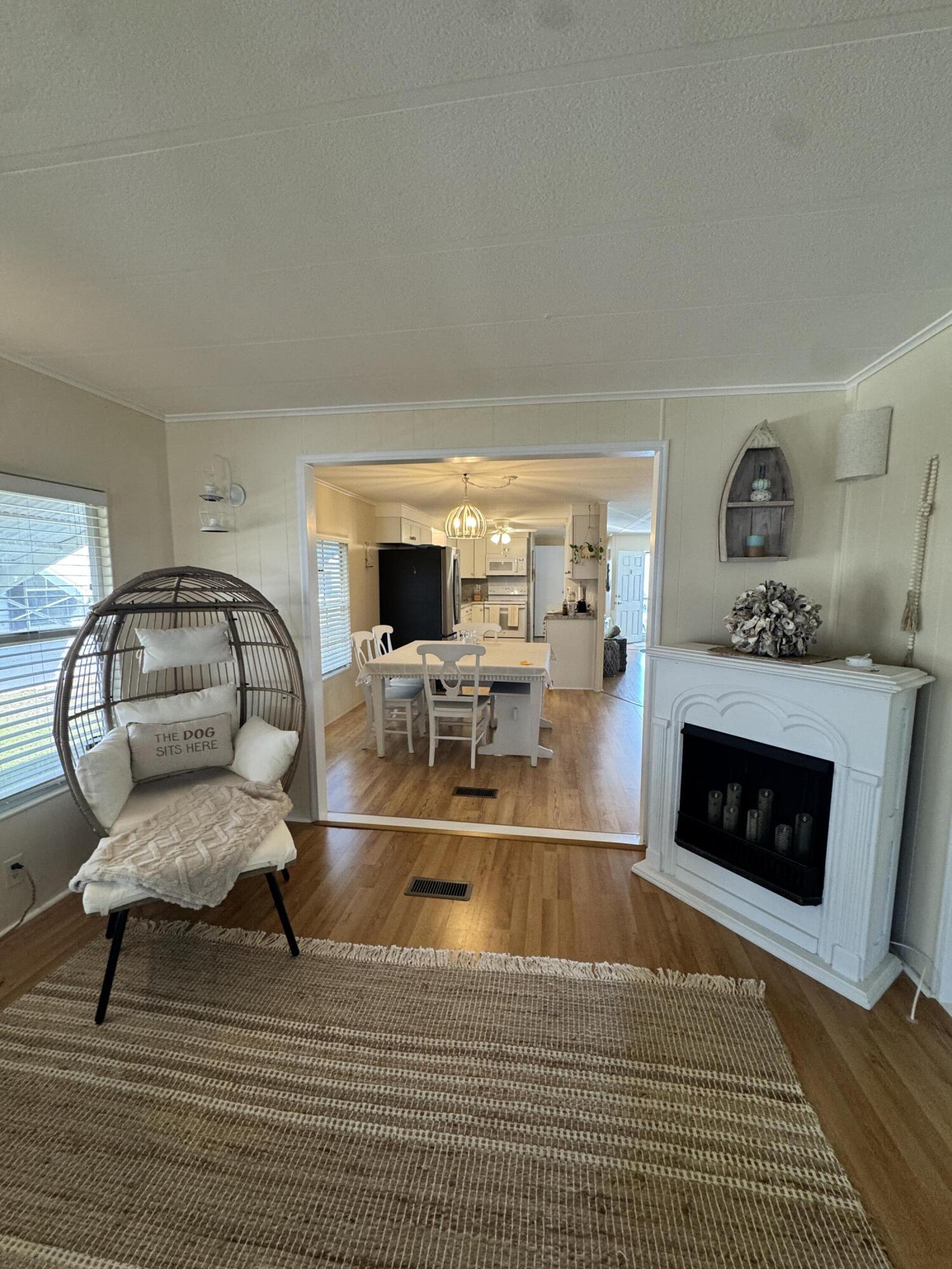 17 Verde Vista Fort Pierce, FL 34951 - Photo 21 of 35 a living room with furniture a fireplace and a flat screen tv
