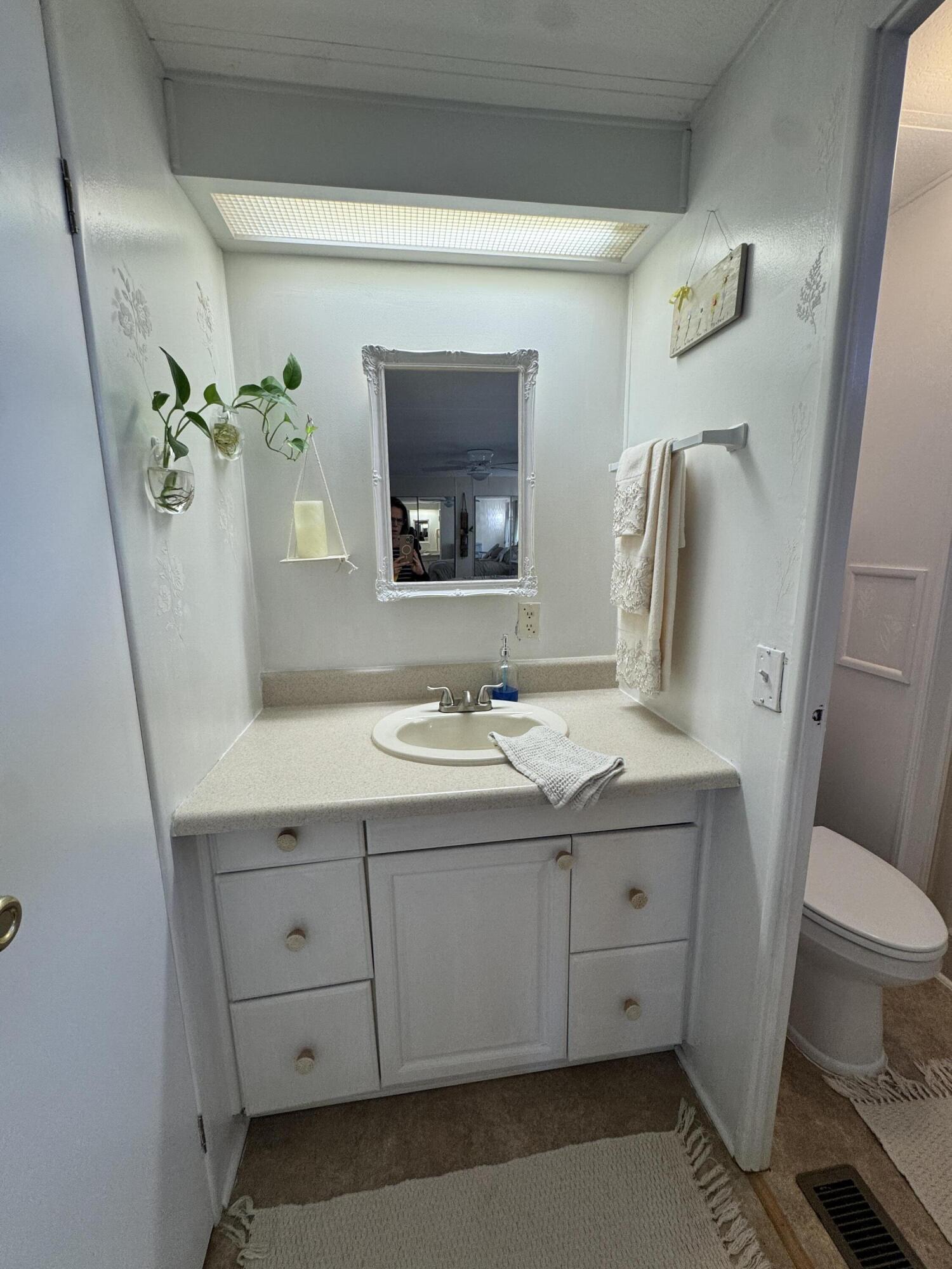17 Verde Vista Fort Pierce, FL 34951 - Photo 26 of 35 a bathroom with a granite countertop sink toilet and mirror