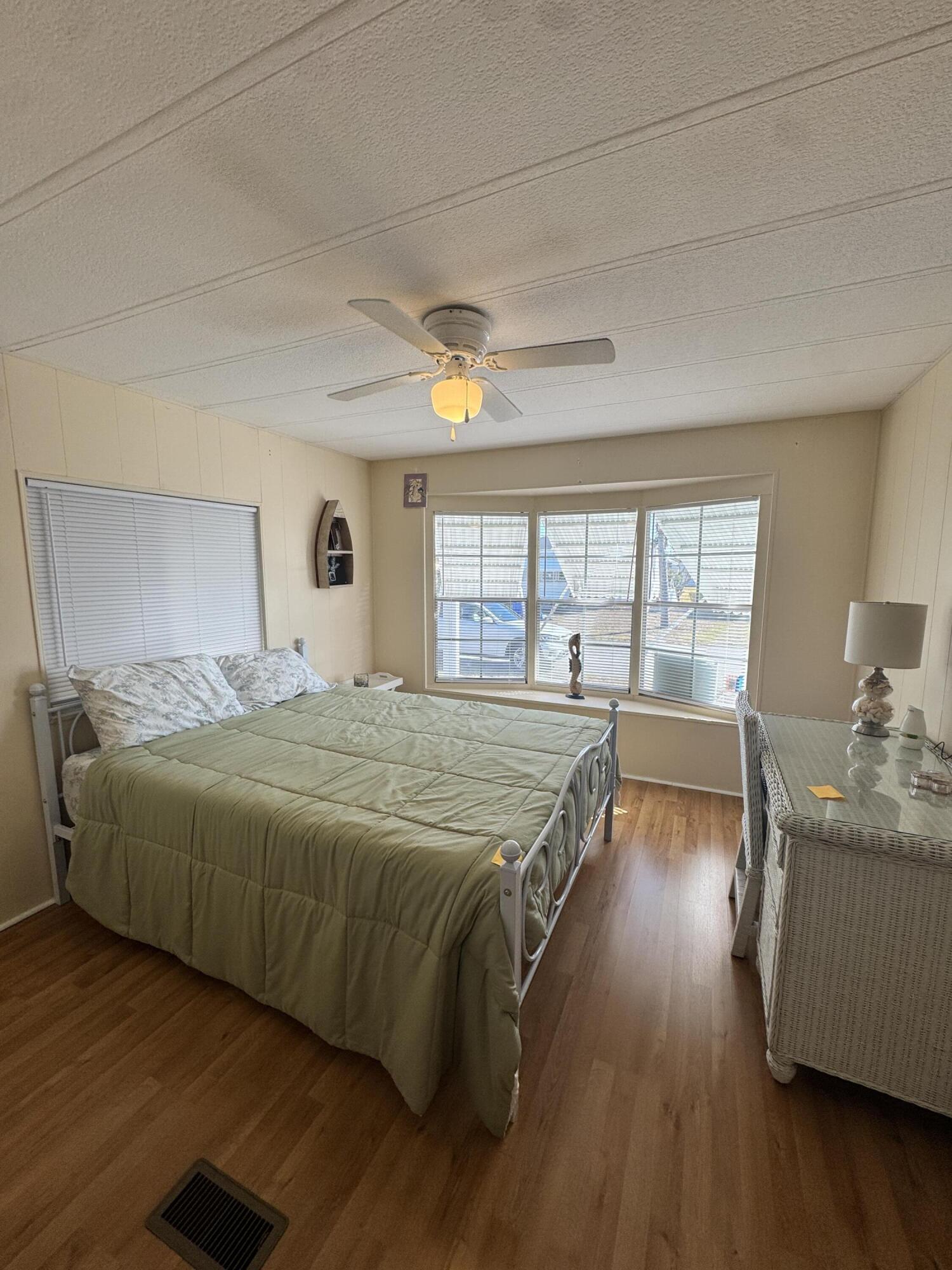 17 Verde Vista Fort Pierce, FL 34951 - Photo 29 of 35 a spacious bedroom with a balcony a bed and wooden floor