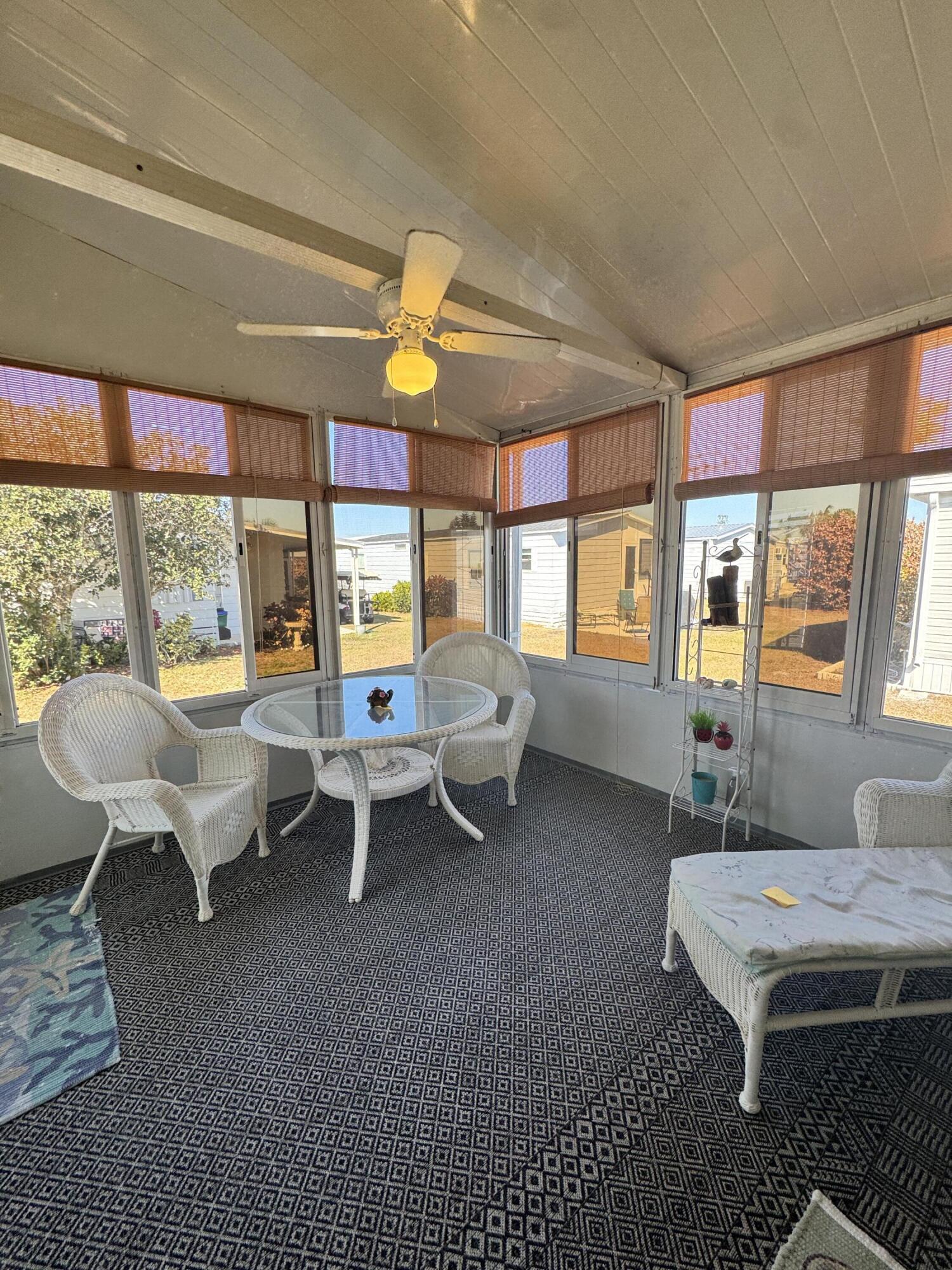 17 Verde Vista Fort Pierce, FL 34951 - Photo 32 of 35 a living room with furniture a fireplace and large windows